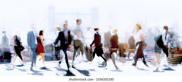 Walking people blur. Lots of people walking in the City of London. Wide panoramic view of people crossing the road. 