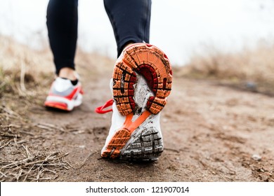 Walking Or Running Legs Sport Shoes, Fitness And Exercising In Autumn Or Winter Nature. Cross Country Or Trail Runner Outdoors.