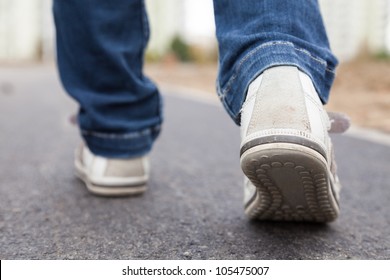 Walking In Sport Shoes On Pavement In Park