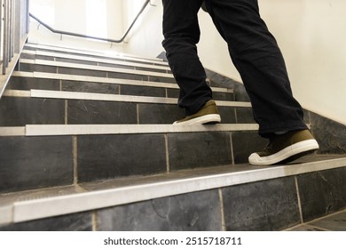 Walking up stairs, asian teenage boy wearing casual shoes in school building. Education, sneakers, learning, movement, ascent - Powered by Shutterstock