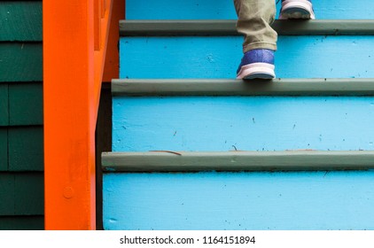 Walking Up Stairs On A Colorful House