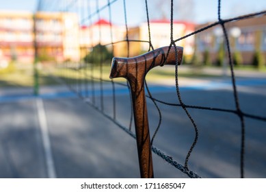 Walking stick hung on a volleyball net.  - Powered by Shutterstock