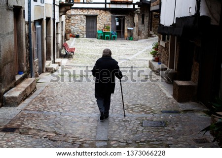 Walking stick old woman. Depopulation concept.