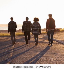 Walking, sunset and back of friends on vacation, travel or holiday together with skateboard. Summer, evening and group of young people by outdoor ocean or sea on weekend trip for bonding in nature. - Powered by Shutterstock