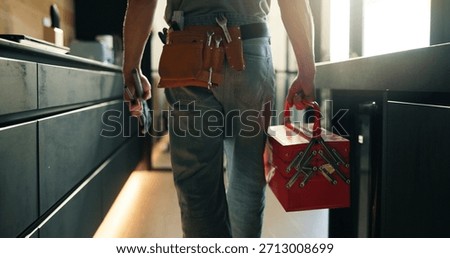 Walking, tool box and back of man in home for maintenance, service or repair job in kitchen. Equipment, customer care and male contractor with plumbing career at client house for leak inspection.
