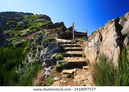 Walking trail at the Pico do Arieiro mountain peak on Madeira island, Portugal - Paved footpath for hikers visiting the third highest mountain of the island
