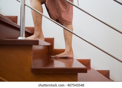 Walking Upstairs In Home With Barefoot. Housewife Concept