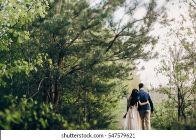 Walking wedding couple in the forest