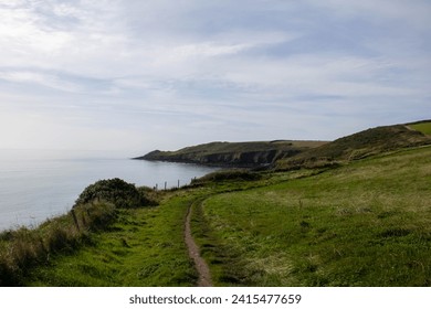 Walking the wild Atlantic way coastal cliffs of East Cork, Ireland. Sun rises over the Atlantic ocean, early Spring. - Powered by Shutterstock