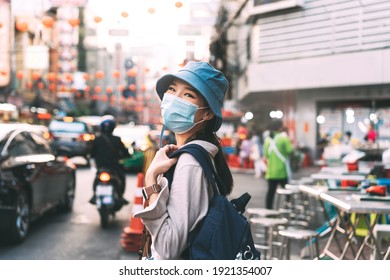 Walking young adult asian woman backpack traveller wear face mask for corona virus or covid-19. People traveling in city lifestyle at outdoor at China town street food market. Bangkok, Thailand - Powered by Shutterstock