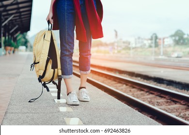 A Walking Young Girl Tourist On Side Railway Holding Smartphone With Backpack Going To Travel Scenery Town Tour Around At Train Station Platform For Take The Rest, Happy And Life Experience Having Fun