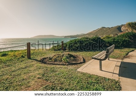 Walkway along the shore and wooden bench overlooking the ocean, California Central Coast
