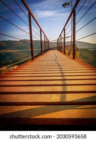 Walkway in a bridge with dramatic sky