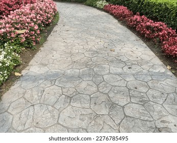 Walkway made of imprinted concrete in the park.The pattern of making a walkway in landscape.