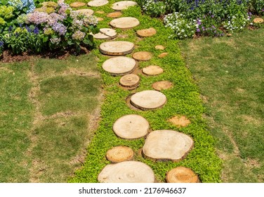 Walkway In The Park Garden Made Of Round Saw Cuts Of Tree Trunks