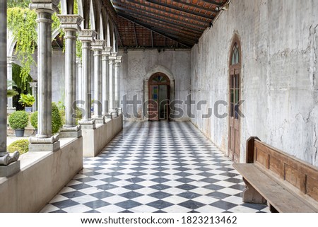 walkway path with checkered pattern marble tiles floor in old cement gothic church
