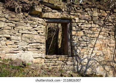 Wall of abandoned old stone house in Slovak mountain village - Shutterstock ID 2118826307