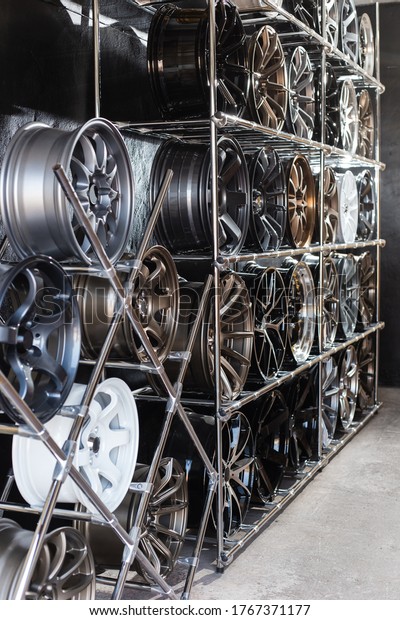 wall of alloy wheels in the store. Auto\
repair shop background. Auto Wheel\
Service\
