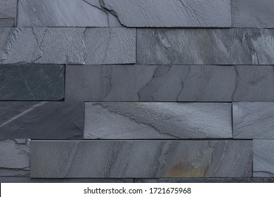 Wall background of volcanic andesite basalt stone texture - architecture background. natural stone facade, wall tiles texture