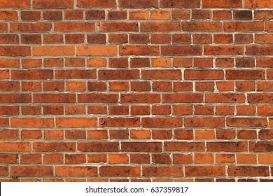Wall of bright red brick with white seams
