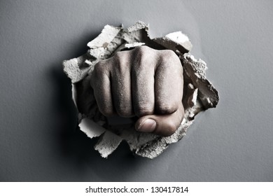 a wall is broken through by a fist