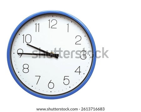 Wall clock with blue frame showing 9.45 09.45 or 21.45 O clock  on white background, suitable for time related articles, education, or punctuality concepts