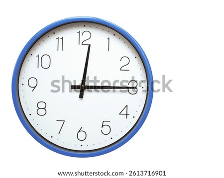 Wall clock with blue frame showing 12.15 00.15 or 12.15 O clock  on white background, suitable for time related articles, education, or punctuality concepts