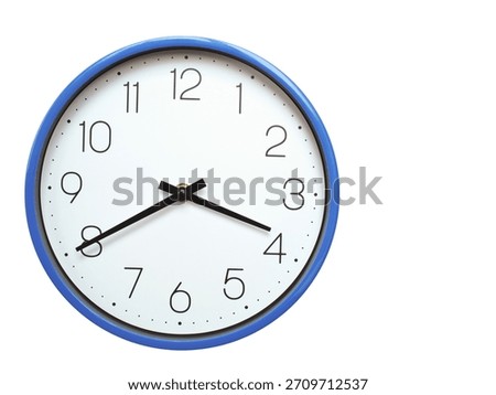 Wall clock with blue frame showing 3.40 03.40 or 15.40 O clock  on white background, suitable for time related articles, education, or punctuality concepts