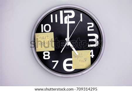 Wall Clock in a Office with a Note Over Nine and Five