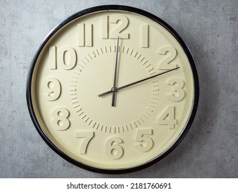 Wall Clock On A Gray Background. Clock Close-up. Watch Face With Large Numbers.