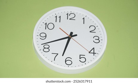 Wall clock on green background - Powered by Shutterstock