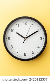 Wall clock on a yellow background.