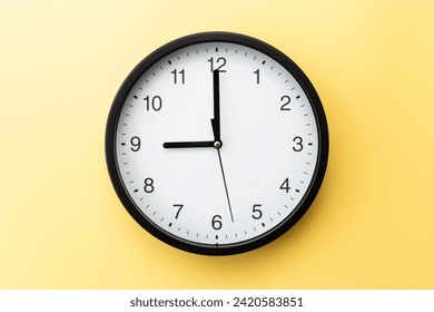 Wall clock on a yellow background. - Powered by Shutterstock