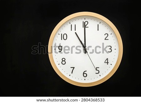 Wall clock showing eleven o'clock. 23:00