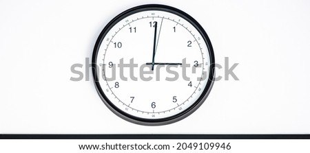 Wall clock shows time 3 o'clock on white isolated background. Round wall clock - front view. Fifteen o'clock
