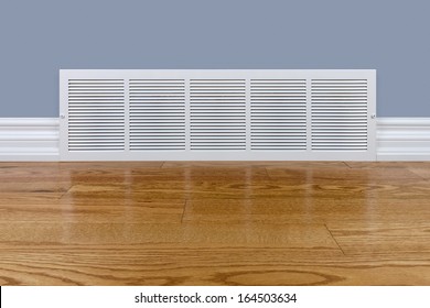 Wall Cold Air Return Grille Sitting On Hardwood Floor