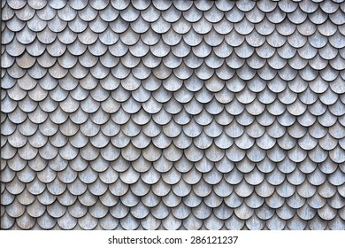 The wall covered with wooden shingles - wooden background horizontal.