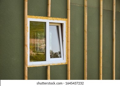 Wall Covering Of The Frame House With Panels Of Vinyl Siding. Construction Or Reconstruction, Repair Of The House. Installation Of Plastic Windows In A New Residential Building.