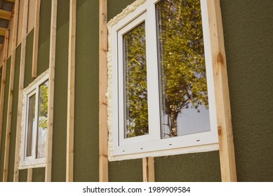 Wall Covering Of The Frame House With Panels Of Vinyl Siding. Construction Or Reconstruction, Repair Of The House. Installation Of Plastic Windows In A New Residential Building.