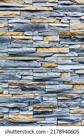 The wall covering is made of canyon facing stone. Pattern and texture of artificial decorative stone