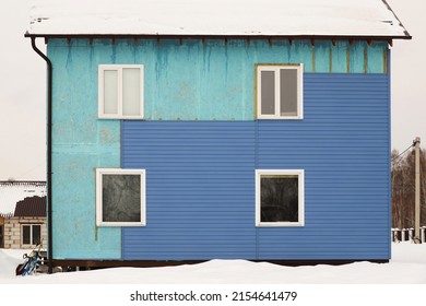 Wall Covering Of The Old House With Panels Of Vinyl Siding. Construction And Facade Reconstruction. Repair Of The House