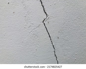 wall cracks cracks erosion erosion of the wall damaged  wall surface peeling off damaged white wall background.