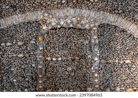 Wall created from human bones and skulls creating macabre designs in The Chapel of Bones located in the city of Évora in Portugal.
It was built on the initiative of three Franciscan monks.