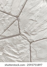 Wall decoration with artificial wild gray stone of arbitrary shape. Finishing works, wall cladding. Close-up.