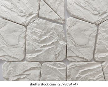 Wall decoration with artificial wild gray stone of arbitrary shape. Finishing works, wall cladding. Close-up.