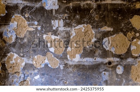 Wall facade in the old hall of an industrial ruin with a clearly visible rough wall structure. Dirty, light background with dust, dirt and traces. Chipped plaster and traces of work. Lost place in Ger
