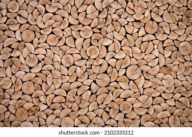 Wall of firewood, background of dry chopped firewood. Wooden background. Natural texture.