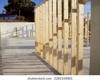 Wall frame being built on a slab-on-grade single story berm home.  - Shutterstock ID 2282104005