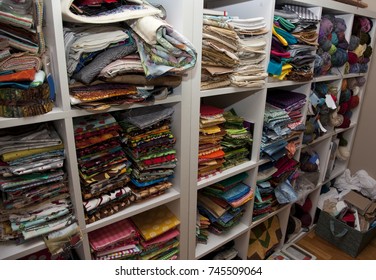 A Wall Full Of Shelves Of Colorful Sewing And Quilting Fabric And Knitting Wool In A Craft Room 