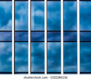 wall with glass windows and the reflection of clouds